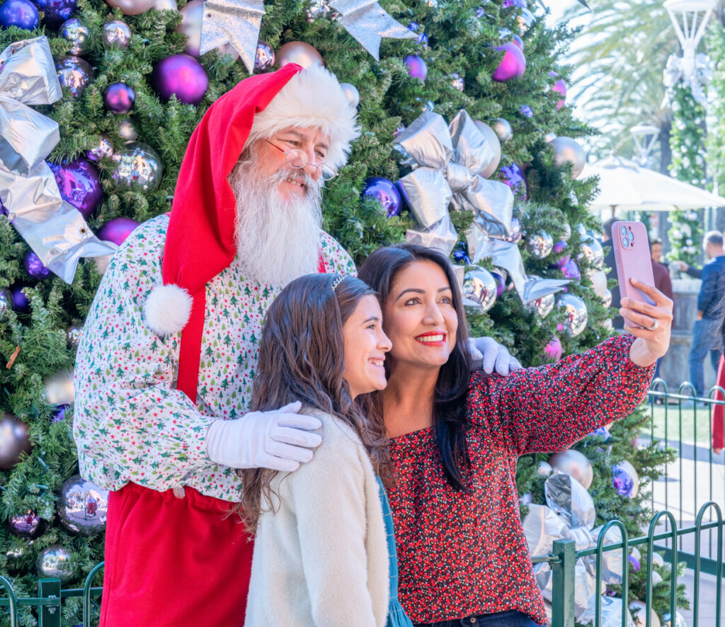 Mom and daughter taking self portrait with Santa