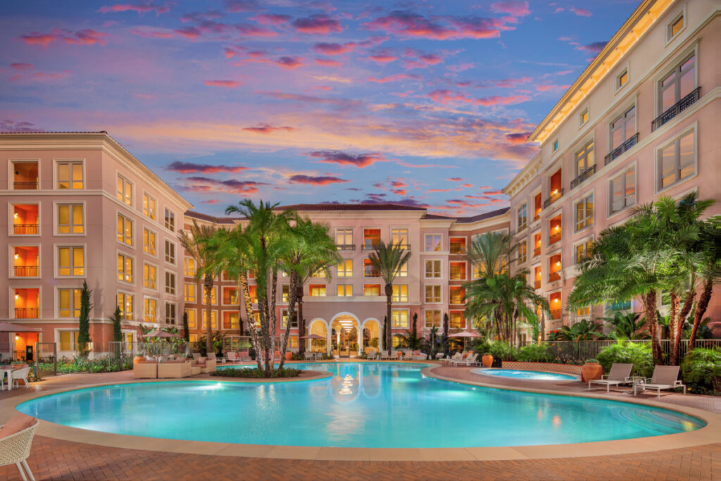 View of the Colonnade Apartment Community pool at dusk.