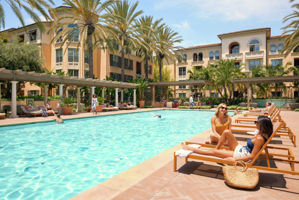 Residents hanging out in the Irvine apartment homes community pool